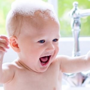 Close up of baby playing in a bath