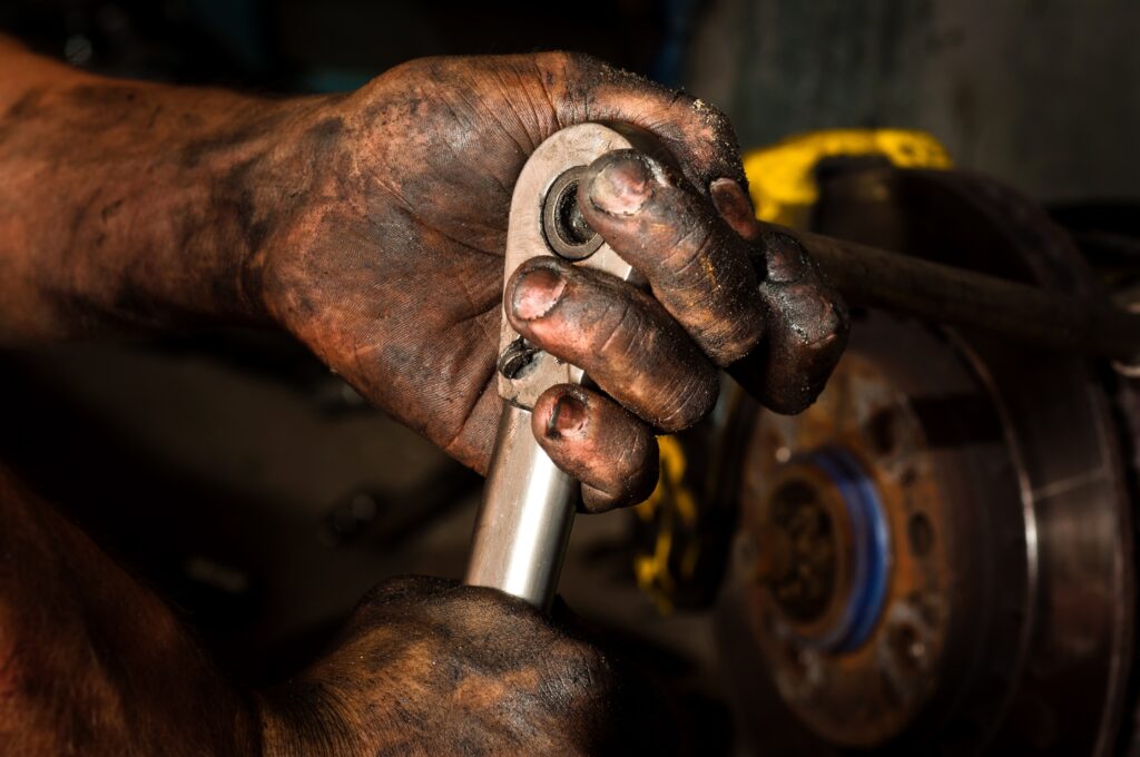 Dirty hands covered in car grease